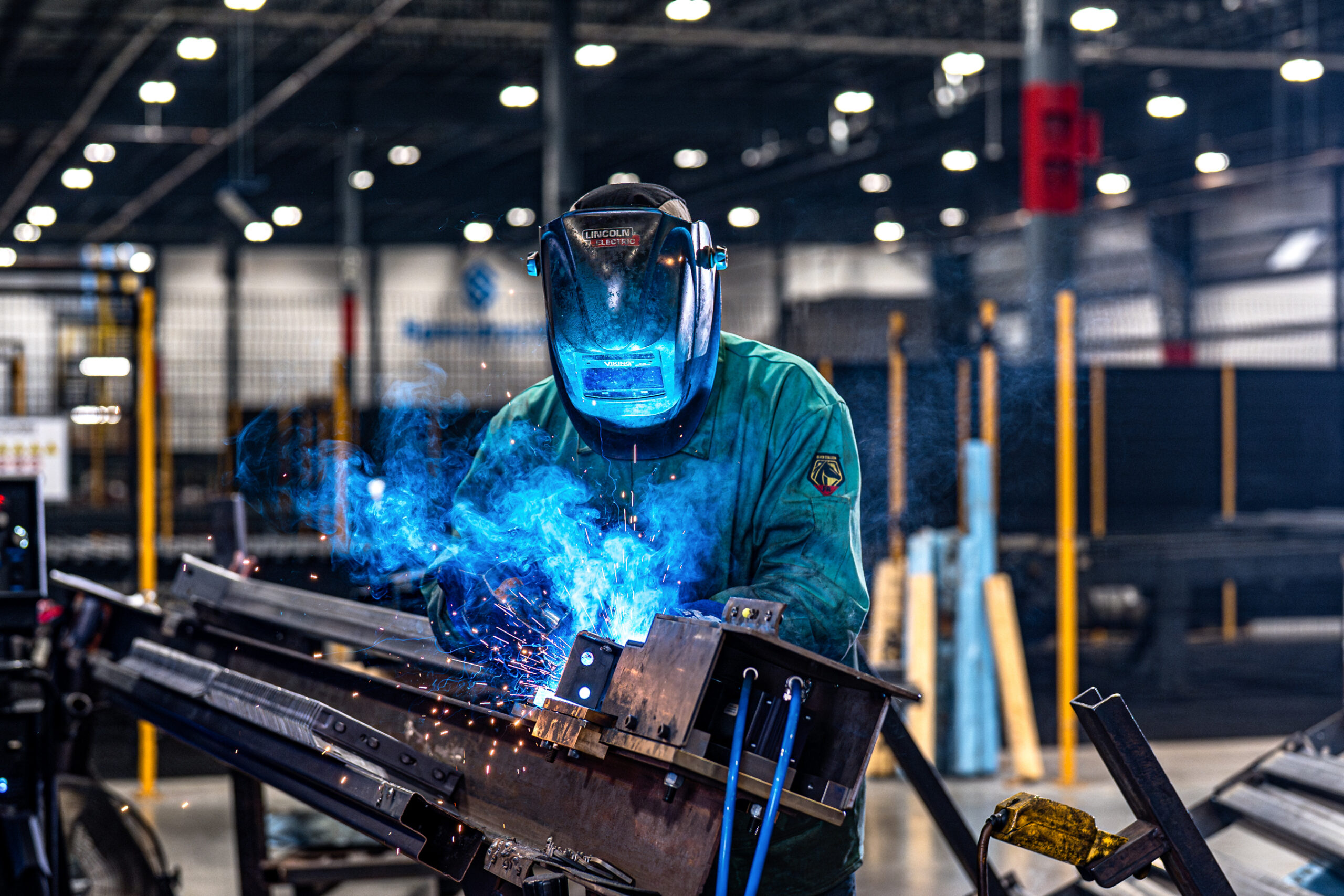 Welder with sparks and blue flame